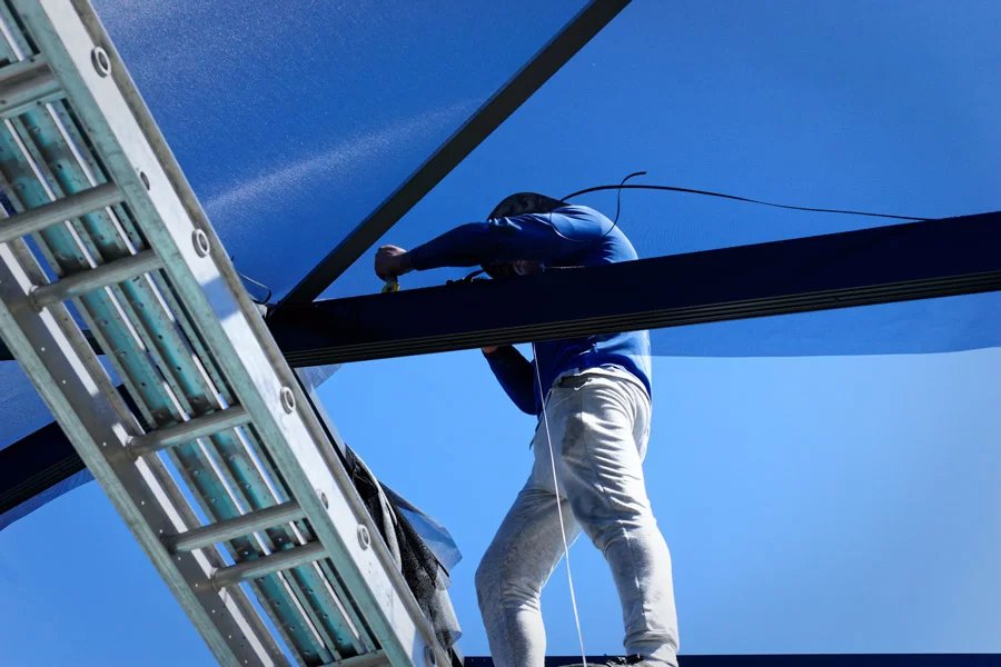Pool screen repair in Kissimmee, FL with technician working on enclosure frame
